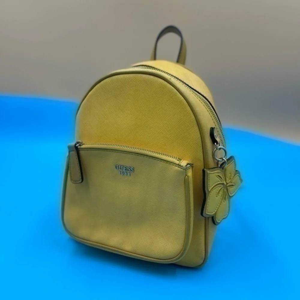 guess mini backpack yellow Little Bay For Women, : Buy Online at Best Price in KSA Dual top handles with 3 drop Guess | Mercari